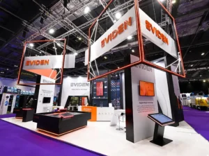 A striking exhibition stand in white, orange and black for Eviden, showing their engagement tools